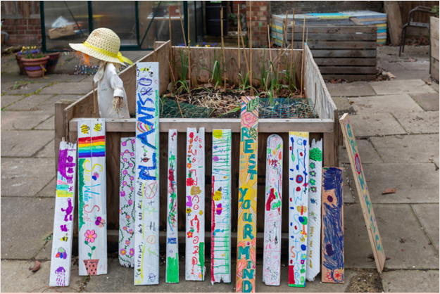 Garden planter with decorated boards