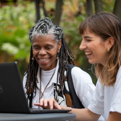 two women looking at a laptop